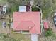 A bird's eye view of a cozy home with a red tiled roof and boats parked nearby at 128 Lake Ring Dr, Winter Haven, FL 33884