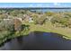 Lakeside home with a backyard view, surrounded by mature trees and a sense of tranquility at 128 Lake Ring Dr, Winter Haven, FL 33884