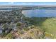A high angle view showcases a lakeside community enveloped by trees and waterways at 128 Lake Ring Dr, Winter Haven, FL 33884