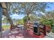 Outdoor area features a deck, grill, and view of the lake, perfect for outdoor entertaining at 128 Lake Ring Dr, Winter Haven, FL 33884