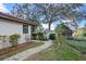 Charming backyard featuring a brick path, lush landscaping, and a glimpse of the lake at 128 Lake Ring Dr, Winter Haven, FL 33884