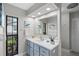 Bathroom featuring a large mirror, neutral paint, and a window with natural light at 128 Lake Ring Dr, Winter Haven, FL 33884