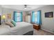 Bright bedroom with two windows and a ceiling fan above the bed at 128 Lake Ring Dr, Winter Haven, FL 33884