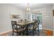 Bright dining room featuring a wooden table and seating for six with beach themed decor at 128 Lake Ring Dr, Winter Haven, FL 33884