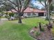 Beautiful single-story home featuring a red tile roof, attached garage, and landscaped front yard at 128 Lake Ring Dr, Winter Haven, FL 33884