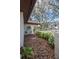 Front yard with lush landscaping, a charming pathway, and a glimpse of the home's architecture at 128 Lake Ring Dr, Winter Haven, FL 33884