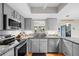 Modern kitchen with granite countertops, stainless steel appliances, and ample cabinet space at 128 Lake Ring Dr, Winter Haven, FL 33884