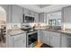 Well-equipped kitchen featuring stainless steel appliances, granite countertops, and modern lighting at 128 Lake Ring Dr, Winter Haven, FL 33884