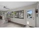 Sunny Living Room features barstools, slider to screened patio, and door to dining area at 128 Lake Ring Dr, Winter Haven, FL 33884