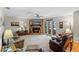 Spacious living room with a stone fireplace, comfortable seating, and natural light at 128 Lake Ring Dr, Winter Haven, FL 33884