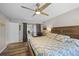 Comfortable main bedroom with wood flooring and a sliding glass door to the patio at 128 Lake Ring Dr, Winter Haven, FL 33884