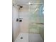 Sleek glass-enclosed shower with modern fixtures and marble-tiled walls at 128 Lake Ring Dr, Winter Haven, FL 33884