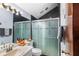 Sleek bathroom with modern shower, tile, and new fixtures at 15 Casarena Ct, Winter Haven, FL 33881