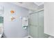 Bright bathroom featuring a glass enclosed shower, modern fixtures, and wall art at 15 Casarena Ct, Winter Haven, FL 33881