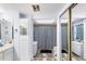 Bathroom features a double vanity, a skylight, and a shower with patterned curtain at 15 Casarena Ct, Winter Haven, FL 33881