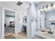 Bathroom features a light grey vanity with marble top, as well as a view to a bright bedroom at 15 Casarena Ct, Winter Haven, FL 33881