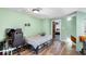 Bedroom features wood-look floors, light green walls, and a large window at 15 Casarena Ct, Winter Haven, FL 33881