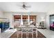 Bright dining room features a white table, tiled floors, and sliding glass doors to the yard at 15 Casarena Ct, Winter Haven, FL 33881