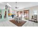 Bright dining area with a large window, vaulted ceilings, tile floors, and modern furnishings at 15 Casarena Ct, Winter Haven, FL 33881