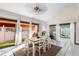Dining room with white tile flooring and large windows overlooking the outdoor space and manicured lawn at 15 Casarena Ct, Winter Haven, FL 33881
