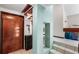 Modern foyer features a wood door, display shelving, tile flooring, and an open staircase to the second floor at 15 Casarena Ct, Winter Haven, FL 33881
