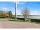Scenic view of lake and gazebo from paver parking area and sidewalk at 15 Casarena Ct, Winter Haven, FL 33881