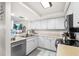 Well-lit kitchen with stainless steel appliances, tile backsplash and stone countertops at 15 Casarena Ct, Winter Haven, FL 33881