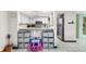 Kitchen with white cabinets, stainless steel appliances and adjacent seating/play area at 15 Casarena Ct, Winter Haven, FL 33881