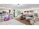 Bright and airy living room featuring tile flooring, an open layout, and a seamless transition to the kitchen at 15 Casarena Ct, Winter Haven, FL 33881