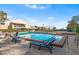 Enjoy the sunshine by this community pool with lounge chairs, a brick deck, and lush landscaping at 15 Casarena Ct, Winter Haven, FL 33881