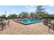 Community pool with brick paver patio and lounge chairs at 15 Casarena Ct, Winter Haven, FL 33881