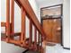 Wooden staircase leads to the upper level of the home; unique front door at 15 Casarena Ct, Winter Haven, FL 33881