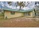The house has a metal roof and an open backyard area, perfect for outdoor activities and enjoyment at 151 W Hamlin Trl, Frostproof, FL 33843