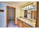 Bathroom featuring a wood vanity with a white countertop and a view of a walk-in closet at 151 W Hamlin Trl, Frostproof, FL 33843