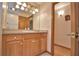 Bathroom featuring a granite countertop vanity with a sink, decorative lighting, and light-colored cabinets at 151 W Hamlin Trl, Frostproof, FL 33843
