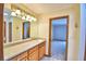 Bathroom featuring a wood vanity with white countertops and a large mirror at 151 W Hamlin Trl, Frostproof, FL 33843
