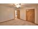 This bedroom includes carpet, ceiling fan, closet doors, and natural light, creating a cozy atmosphere at 151 W Hamlin Trl, Frostproof, FL 33843