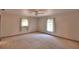 Bedroom features natural light, carpet, a ceiling fan, and dual windows for a pleasant ambiance at 151 W Hamlin Trl, Frostproof, FL 33843