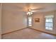 Bedroom features neutral carpeting and windows with decorative curtains, creating a cozy feel at 151 W Hamlin Trl, Frostproof, FL 33843