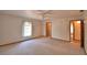 Bright bedroom featuring neutral carpeting, ceiling fan, and natural light from the large window at 151 W Hamlin Trl, Frostproof, FL 33843