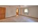 Bedroom showcasing carpet flooring, natural light from the window, and access to an en-suite bathroom at 151 W Hamlin Trl, Frostproof, FL 33843