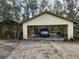 Open carport providing covered parking space, with green roof and a vehicle inside at 151 W Hamlin Trl, Frostproof, FL 33843