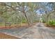 Long private driveway leading to a secluded property surrounded by trees at 151 W Hamlin Trl, Frostproof, FL 33843