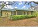 Charming single-story home with a screened-in porch and mature trees at 151 W Hamlin Trl, Frostproof, FL 33843