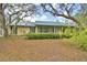 Charming single-story home with a screened-in porch and mature trees at 151 W Hamlin Trl, Frostproof, FL 33843