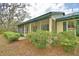 Charming house featuring a screened-in porch and lush landscaping at 151 W Hamlin Trl, Frostproof, FL 33843
