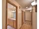 Hallway view showcasing a bathroom entrance, closet, hardwood floors, and neutral decor at 151 W Hamlin Trl, Frostproof, FL 33843