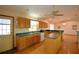Well-lit kitchen featuring wood cabinetry, a center island, and modern appliances at 151 W Hamlin Trl, Frostproof, FL 33843