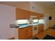 A functional kitchen featuring wood cabinets, tile countertops, and modern appliances at 151 W Hamlin Trl, Frostproof, FL 33843