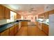 Large kitchen featuring wood cabinetry, a center island, and modern appliances at 151 W Hamlin Trl, Frostproof, FL 33843